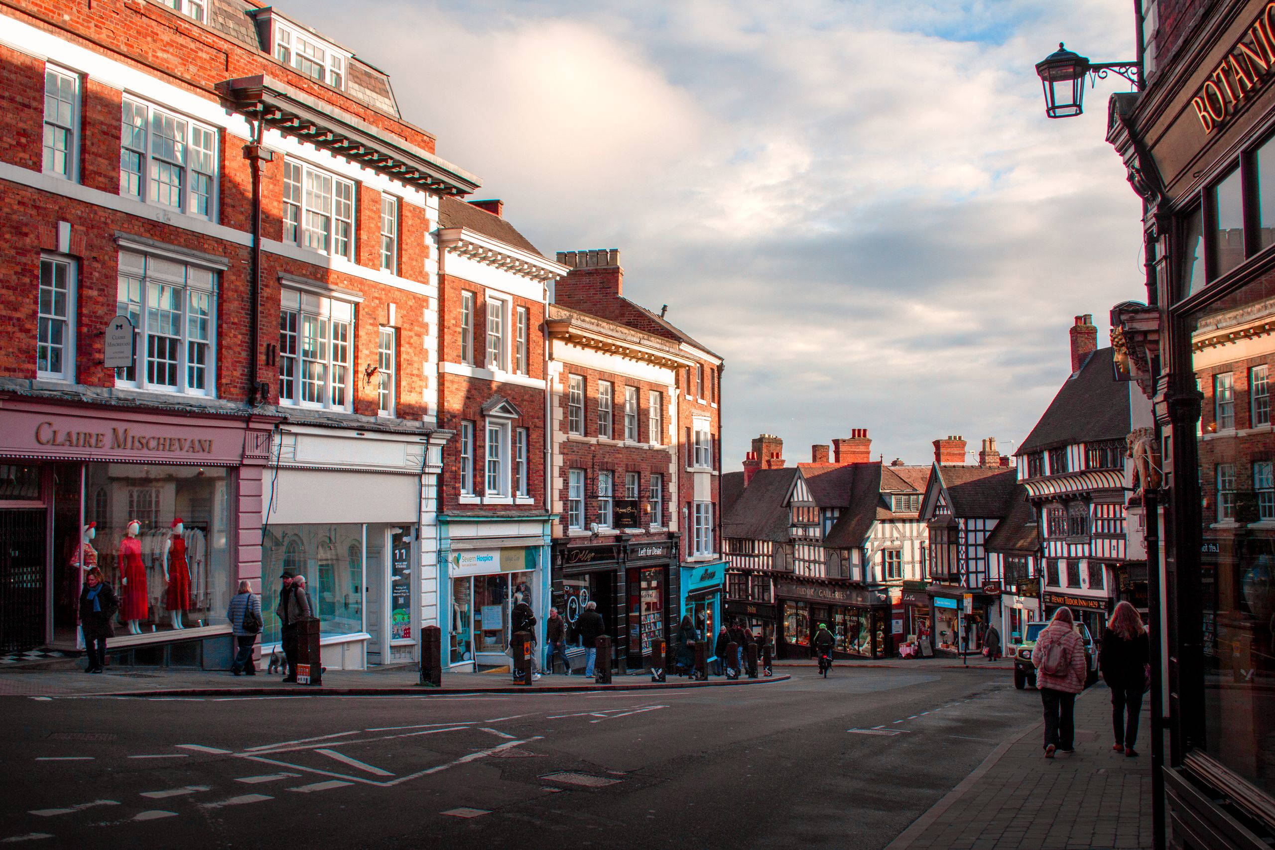 Picturesque street view of Shrewsbury's historic architecture under afternoon sun.