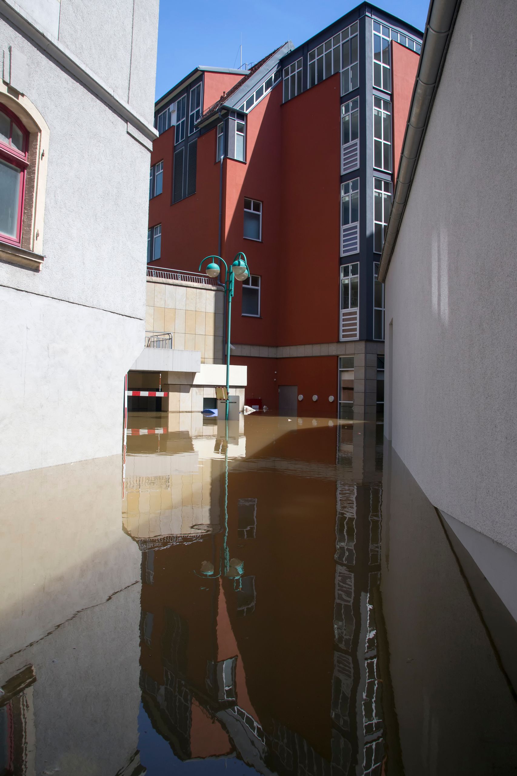 Urban flooding scene showing waterlogged street and buildings.